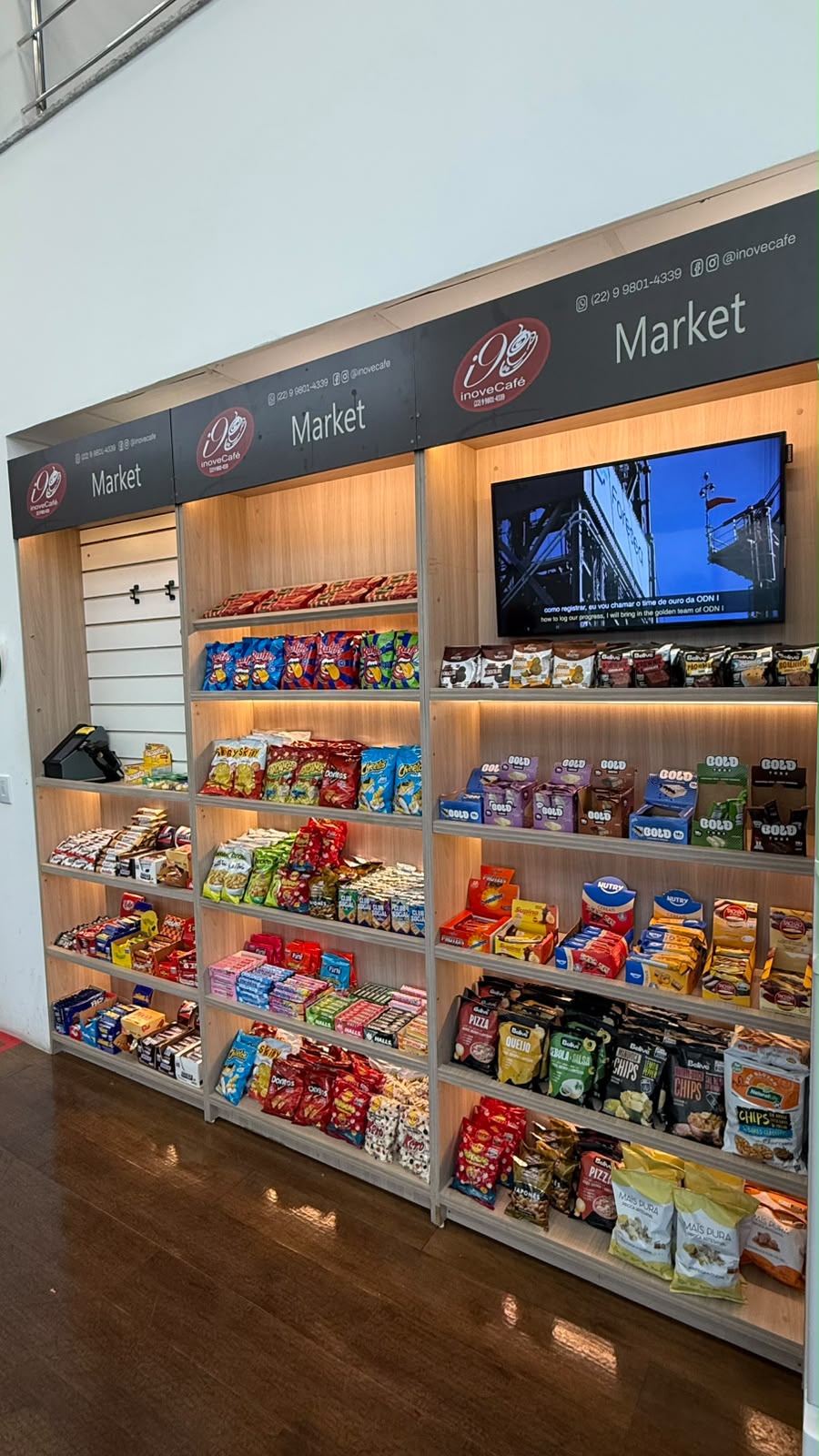 Micro-Mercado instalado com três módulos de prateleiras, produtos variados e ponto de pagamento.